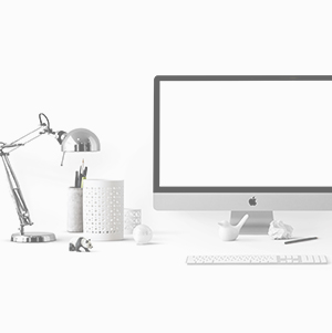 Desk top with computer, lamp and writing instruments